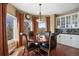 Bright breakfast nook with a circular table, four chairs, and built-in display cabinets at 724 Evening Star Dr, Castle Rock, CO 80108