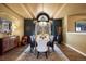 Formal dining room featuring a modern chandelier, arched ceiling, and access to outdoor views for elegant entertaining at 724 Evening Star Dr, Castle Rock, CO 80108