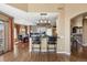 Eat-in kitchen features hardwood floors, an island, and granite countertops connecting to the dining area at 724 Evening Star Dr, Castle Rock, CO 80108