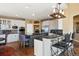 Bright kitchen features a center island with seating, stainless appliances, and dark granite countertops at 724 Evening Star Dr, Castle Rock, CO 80108