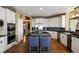 This spacious kitchen features white cabinets, stainless appliances and large island with seating at 724 Evening Star Dr, Castle Rock, CO 80108