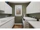 Well-lit laundry room with modern appliances, and plenty of counter space at 724 Evening Star Dr, Castle Rock, CO 80108