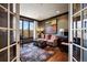 Cozy living room featuring hard wood floors, a large window, and warm neutral tones at 724 Evening Star Dr, Castle Rock, CO 80108