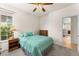 Charming bedroom with window, ceiling fan and adjacent hallway at 22263 E Euclid Dr, Aurora, CO 80016