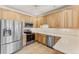 Bright kitchen with light wood cabinets and stainless steel appliances at 22263 E Euclid Dr, Aurora, CO 80016