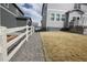 Backyard featuring lawn space, white fence and rock landscaping at 4955 Trails Edge Ln, Castle Rock, CO 80104