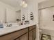 Bathroom featuring a double sink vanity and a separate shower and toilet area at 4955 Trails Edge Ln, Castle Rock, CO 80104