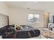 Bedroom with gray tufted headboard, dark bedding, a window, and a TV stand at 4955 Trails Edge Ln, Castle Rock, CO 80104