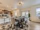 Open dining area with modern table and bench seating adjacent to kitchen at 4955 Trails Edge Ln, Castle Rock, CO 80104