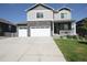 Charming two-story home featuring stone accents, a large driveway, and a welcoming front porch at 4955 Trails Edge Ln, Castle Rock, CO 80104