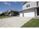 View of a home with a large driveway and a welcoming front porch at 4955 Trails Edge Ln, Castle Rock, CO 80104