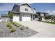 Charming two-story home featuring stone accents, a large driveway, and beautifully landscaped yard at 4955 Trails Edge Ln, Castle Rock, CO 80104