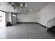 Large two-car garage with concrete flooring and white walls, providing ample space for vehicles and storage at 4955 Trails Edge Ln, Castle Rock, CO 80104