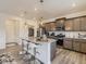 Stylish kitchen with island, pendant lighting, stainless appliances, and pantry at 4955 Trails Edge Ln, Castle Rock, CO 80104