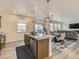 Modern kitchen island open to living room and dining area at 4955 Trails Edge Ln, Castle Rock, CO 80104