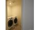 Clean laundry room with modern front-load washer and dryer set at 4955 Trails Edge Ln, Castle Rock, CO 80104