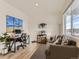 Cozy living room with a sofa, large window, wood flooring, and a decorated desk setup at 4955 Trails Edge Ln, Castle Rock, CO 80104