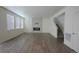 Bright, open living room with fireplace, wood-style floors, and staircase at 4955 Trails Edge Ln, Castle Rock, CO 80104