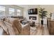 Comfortable living room featuring a fireplace, large sofa, and wood floors at 4955 Trails Edge Ln, Castle Rock, CO 80104