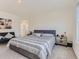 Tranquil main bedroom featuring a large bed and ensuite bathroom access at 4955 Trails Edge Ln, Castle Rock, CO 80104