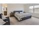 Bright main bedroom with view, furnished with large bed and side tables at 4955 Trails Edge Ln, Castle Rock, CO 80104