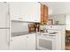 Modern kitchen with white cabinets, granite countertops and white subway tile backsplash at 1629 Trenton St, Denver, CO 80220