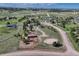 Expansive aerial view of a rural property, showcasing open fields, scattered homes, and equestrian facilities at 36921 Ruger Ct, Elizabeth, CO 80107