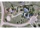Bird's eye view of the property featuring an equestrian ring and outbuildings surrounded by trees at 36921 Ruger Ct, Elizabeth, CO 80107