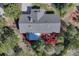 Overhead view of house with sunroom, patio, and mature trees at 36921 Ruger Ct, Elizabeth, CO 80107