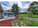 Back of house featuring spacious sunroom with patio and mature landscaped yard at 36921 Ruger Ct, Elizabeth, CO 80107