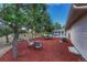 Backyard with patio table and chairs next to home with sunroom at 36921 Ruger Ct, Elizabeth, CO 80107