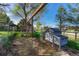 Multiple wooden chicken coops in fenced area under a tree at 36921 Ruger Ct, Elizabeth, CO 80107