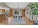 Open dining room showcasing a wood table, modern chairs, and views into the kitchen and sunroom at 36921 Ruger Ct, Elizabeth, CO 80107