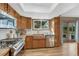 Well-lit kitchen featuring stainless appliances, wood cabinets, and a copper sink under a bright window at 36921 Ruger Ct, Elizabeth, CO 80107