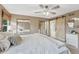 Serene main bedroom with a plush bed, sliding barn door to the ensuite, and ample natural light at 36921 Ruger Ct, Elizabeth, CO 80107