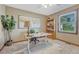 Bright home office with a large desk, decorative plants, and bookshelves at 36921 Ruger Ct, Elizabeth, CO 80107