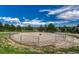 Fenced paddock area with sandy base and blue skies in background at 36921 Ruger Ct, Elizabeth, CO 80107