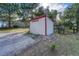 Small red and white shed next to a gravel driveway and bordered by rocks at 36921 Ruger Ct, Elizabeth, CO 80107