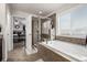 Spa-like bathroom featuring a soaking tub, glass-enclosed shower, and natural light is a relaxing oasis at 21271 E Smoky Hill Rd, Centennial, CO 80015
