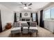 Cozy bedroom with a plush bed, reading chairs, and great natural light creates a serene ambiance at 21271 E Smoky Hill Rd, Centennial, CO 80015