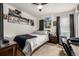 Comfortable bedroom with dark accents, natural light, and a modern design is perfect for rest and relaxation at 21271 E Smoky Hill Rd, Centennial, CO 80015