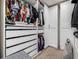 Organized walk-in closet with custom shelving, drawers, and ample hanging space is a storage haven at 21271 E Smoky Hill Rd, Centennial, CO 80015