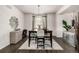 Charming dining room with a stylish light fixture, neutral tones, and seamless flow to the adjacent living space at 21271 E Smoky Hill Rd, Centennial, CO 80015