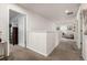 Upstairs hallway with neutral paint and carpet leads to a bedroom and sitting area filled with natural light at 21271 E Smoky Hill Rd, Centennial, CO 80015