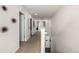Bright hallway features neutral walls, carpet flooring, and access to various rooms, creating an inviting passage at 21271 E Smoky Hill Rd, Centennial, CO 80015