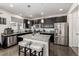 Modern kitchen featuring dark cabinetry, stainless steel appliances, and a granite island at 21271 E Smoky Hill Rd, Centennial, CO 80015