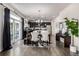 Open-concept kitchen with dark cabinetry, stainless steel appliances, adjacent to a dining area and sliding door to deck at 21271 E Smoky Hill Rd, Centennial, CO 80015