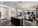 Modern kitchen with stainless appliances, granite island, and open layout to dining, living spaces at 21271 E Smoky Hill Rd, Centennial, CO 80015