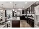 Stylish kitchen featuring dark cabinets, stainless steel appliances, and a granite island at 21271 E Smoky Hill Rd, Centennial, CO 80015