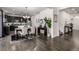 Open-concept kitchen with dark cabinetry, stainless steel appliances, and a dining area featuring a chandelier at 21271 E Smoky Hill Rd, Centennial, CO 80015
